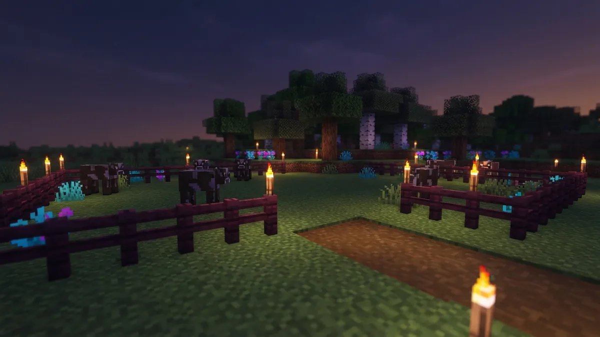 Bright fenced grass pasture prepared for cow spawns in a Minecraft-style world